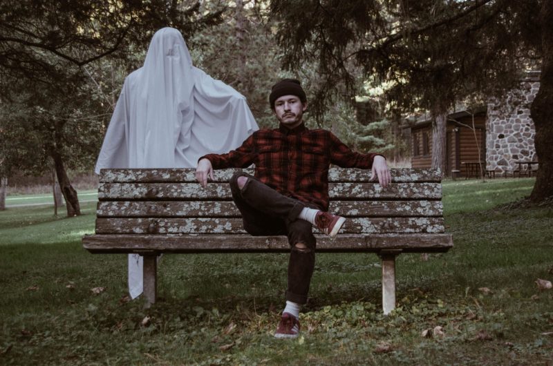 Man on bench with ghost